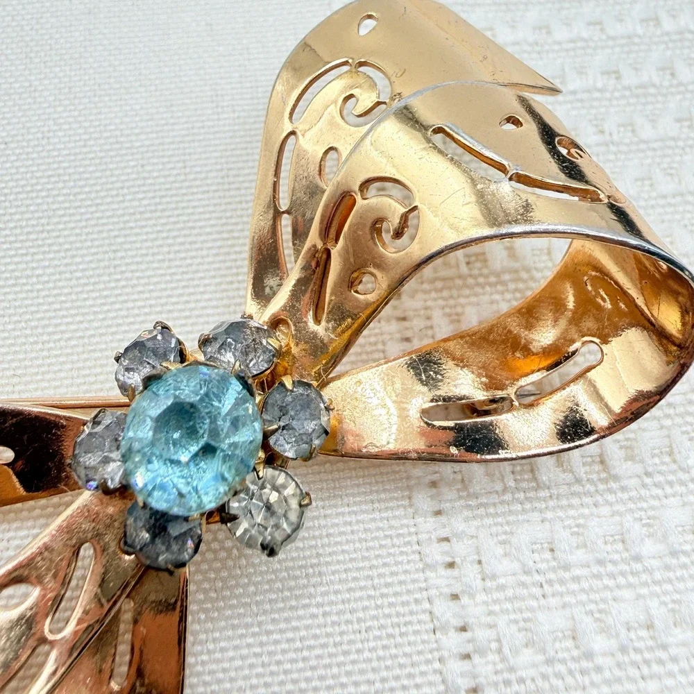 Vintage CORO Gray and Blue Rhinestones Gold Tone Cutout Bow Pin Brooch